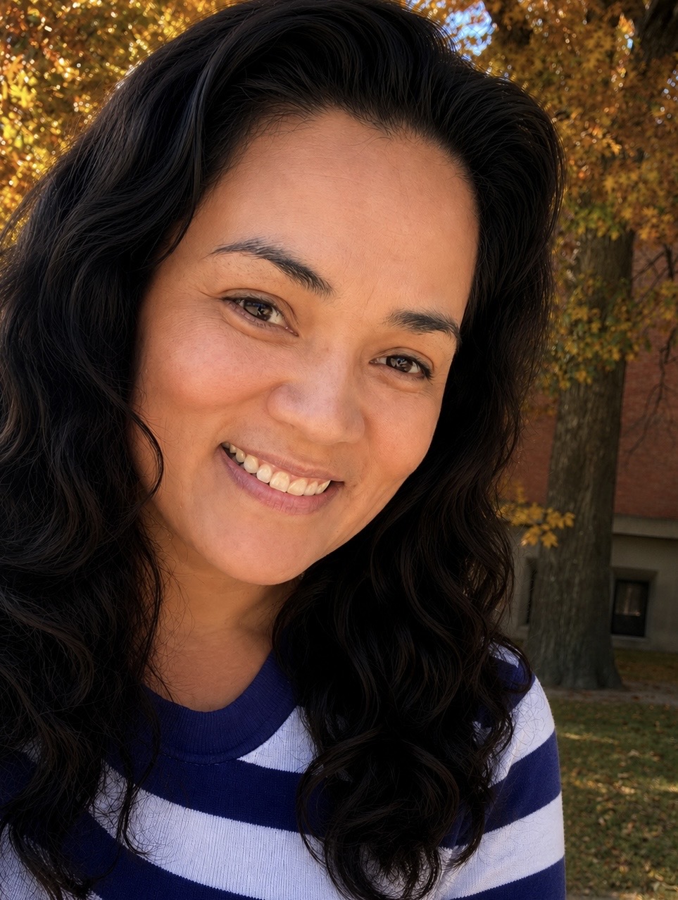 Theresa Bryan smiling outdoors in autumn